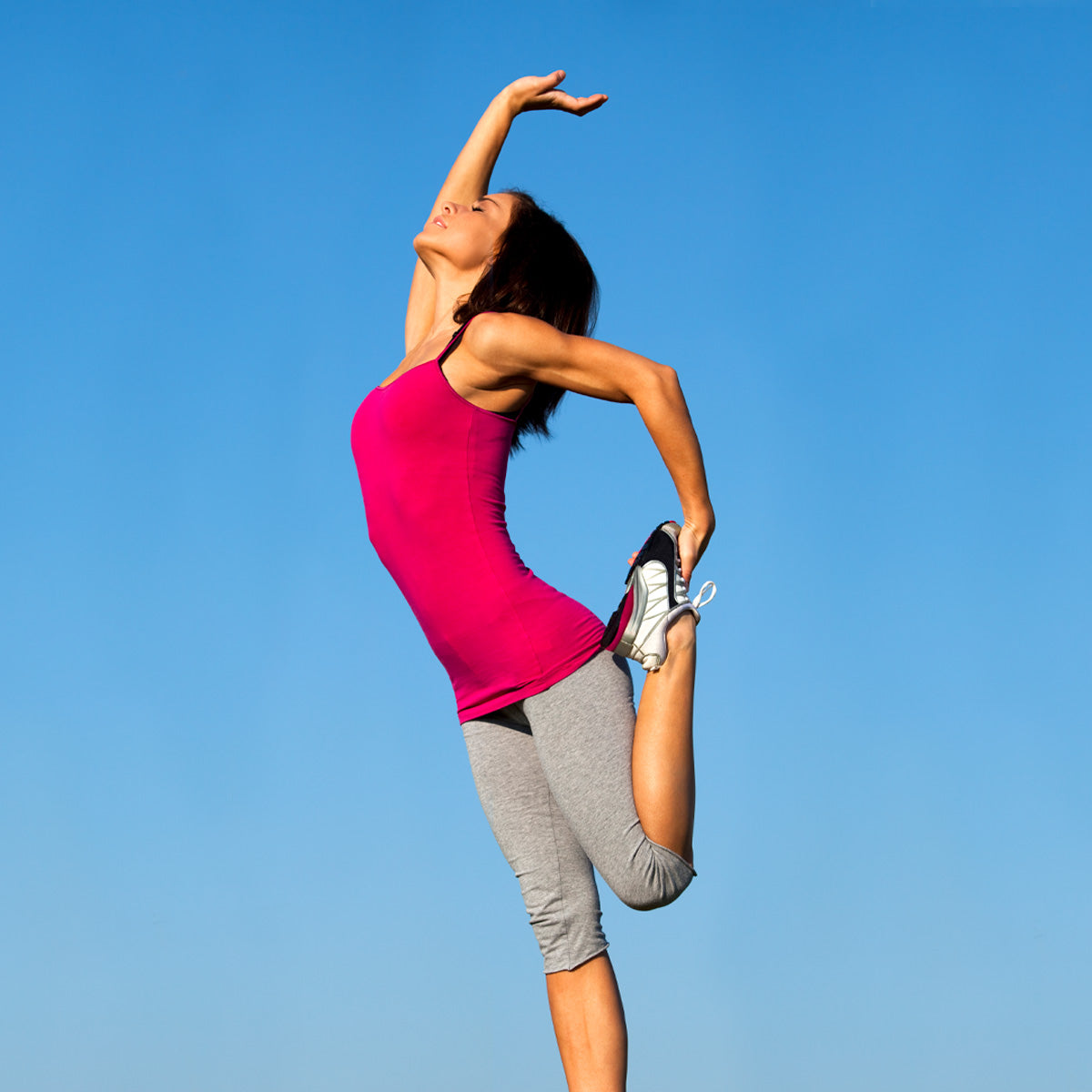 Right, woman stretching in athletic wear.