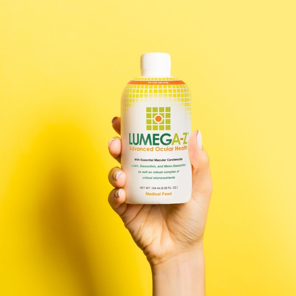 Hand holding Lumega-Z bottle.