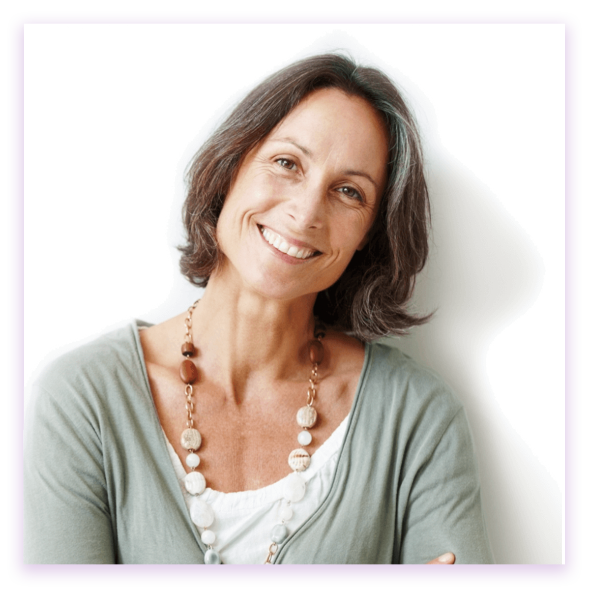 Menopausal Woman smiling in light green shirt and a necklace.