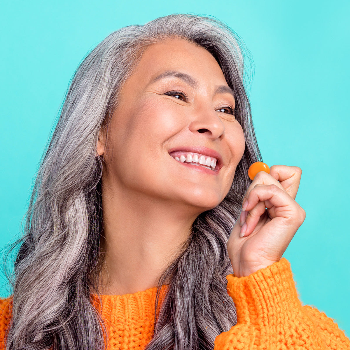 Left, Elderly woman smiling and holding a Viactiv Omega Boost Gel Bite.