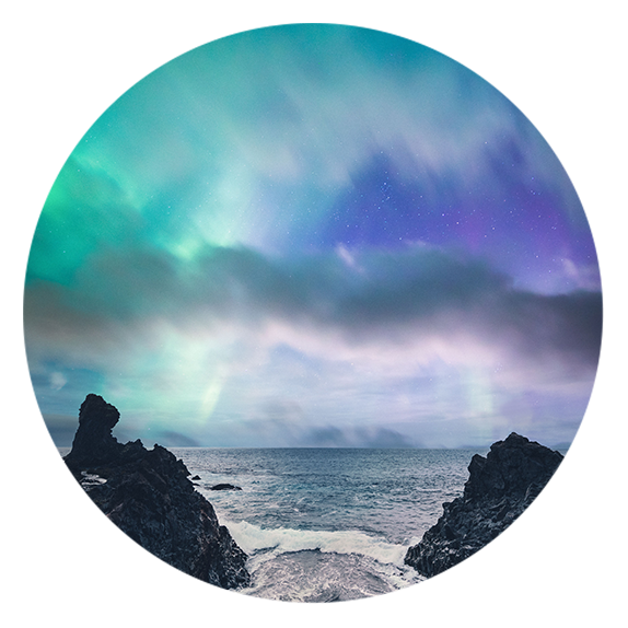 Beautiful beach with two rocks over the water, aurora borealis sky above